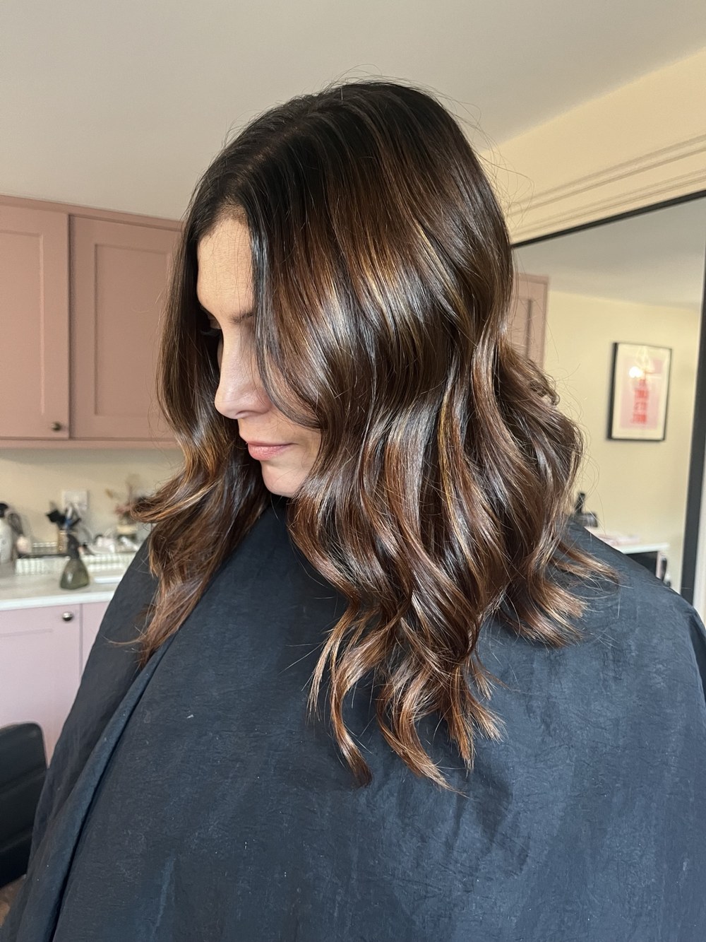 Rich brunette waves with warm highlights by Selina at The Room